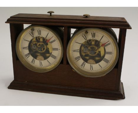 A late 19th century oak chess clock, The Reliable Chess Timer, assembled by William E Tanner, Redhill, Surrey, each 10cm dial