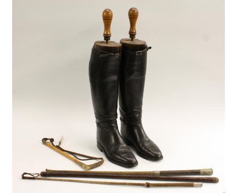 Country Pursuits - a pair of black leather riding boots, the beech trees with turned handles and brass fittings, 55cm high ov