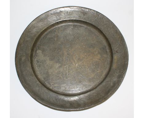 A large French Historicist pewter charger, wrigglework engraved with a named portrait of Henri IV, within a border of foliage