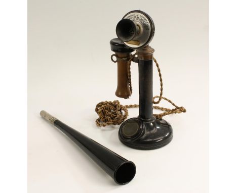An early 20th century candlestick telephone, adjustable pivoting mouthpiece with aluminium instruction plate, domed circular 