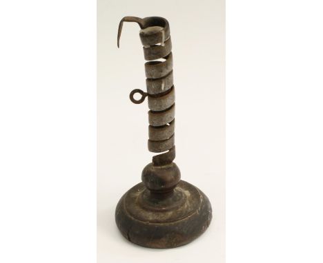 Treen - a primitive iron spiral candlestick, rudimentary ejector, circular base, 21.5cm high, 19th century