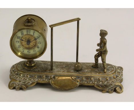 Football - a late Victorian brass novelty timepiece, as a footballer standing before an open goal, the 5cm circular enamel cl