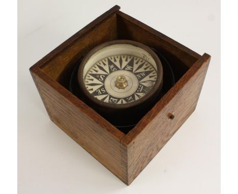 A late 19th/early 20th century nautical gimbal compass, dry card scale, the dovetailed oak case 15.5cm wide, c.1900