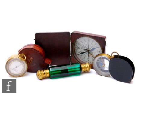 A 19th Century cased brass pocket barometer, James Lucking &amp; Co, Birmingham, two period compasses and a green glass and b