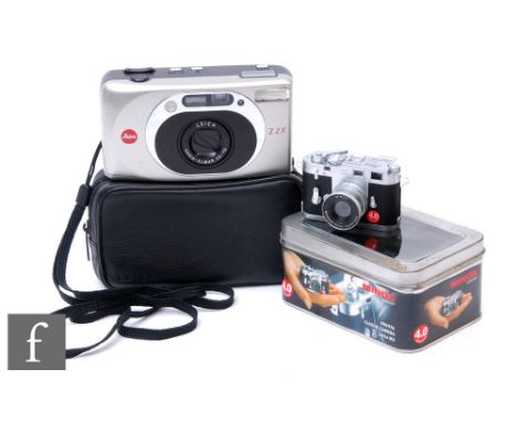 A Minox Leica M3 4.0 digital camera, with presentation tin, together with a Leica Z2X compact camera with sleeve. (2) 