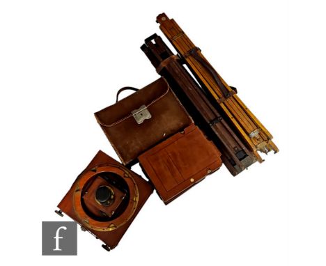A Thornton Pickard mahogany folding half plate camera 'Ruby', with four spare side plates and two tripods, and a Watson quart