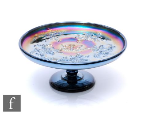 An early 20th Century Carnival glass comport by Crown Crystal, relief moulded to the central well in the Butterfly Bush and W