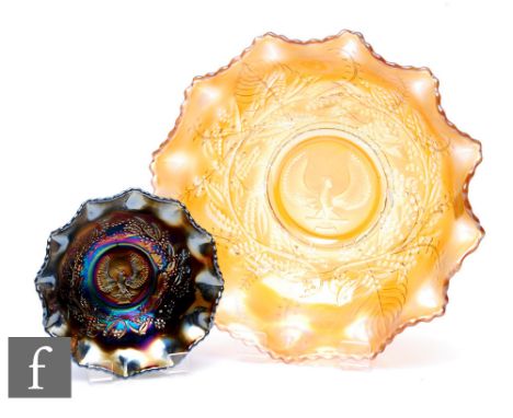 Two early 20th Century Carnival glass bowls by Crown Crystal, each relief moulded to the central well in the Shrike pattern, 