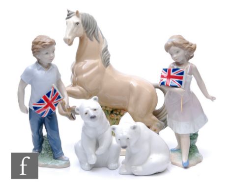 A pair of later 20th Century Spanish Lladro figures titled Their Kingdom - Boy &amp; Girl, modelled as two children carrying 