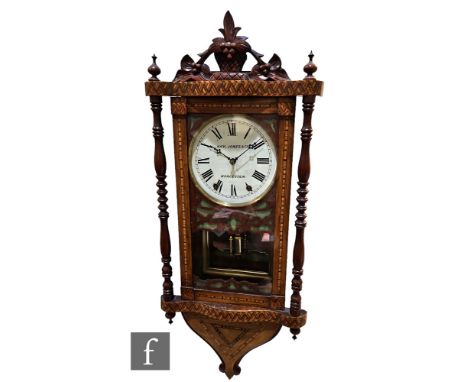 A late 19th Century marquetry veneered walnut wall clock with eight-day movement striking on a bell, with fruiting vine finia