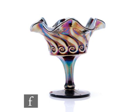 An early 20th Century Carnival glass comport with wave edged rim, facet stem and circular spread foot, by Dugan, relief mould