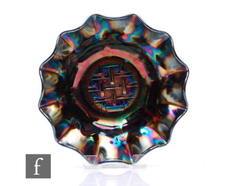 An early 20th Century Carnival glass bowl with wave edged rim, by Crown Crystal, relief moulded to the central well in the St