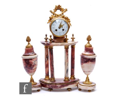 A 20th Century French clock gilt mounted garniture, the movement on a four pillar base with two side urns in the classical st