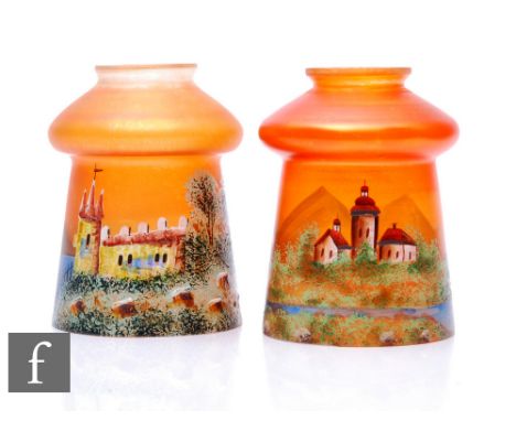 A pair of early 20th Century Czechoslovakian Carnival glass lampshades, each enamel decorated with a landscape over the marig