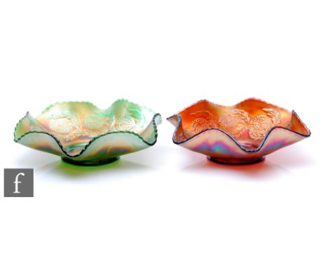 Two early 20th Century Carnival glass bowls with wave edged rims, by Ten Mums, each relief moulded to the central well in the