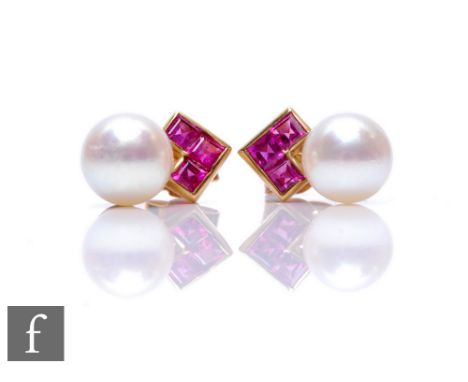 A pair of 9ct cultured pearl and ruby stud earrings, three square cut rubies above a single pearl. 