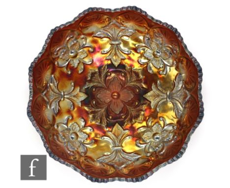 An early 20th Century Carnival glass footed bowl by Millersburg, relief moulded to the central well in the Fleur de Lis patte