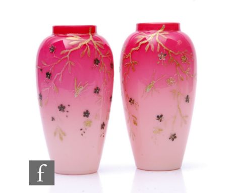 A pair of Harrach peachblow vases, circa 1900, cased in a dye away pink to white over opal and relief gilded with a insects a