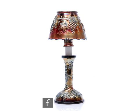 An early 20th Century Carnival glass candle lamp with domed base with slender stem, and shade, by Northwood, relief moulded i