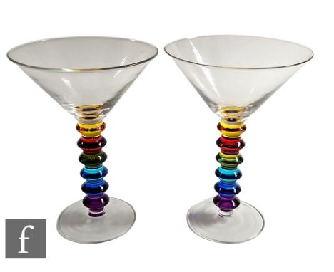 A set of six contemporary cocktail glasses, each with a clear conical bowl above a rainbow coloured bobbin stem and clear cry