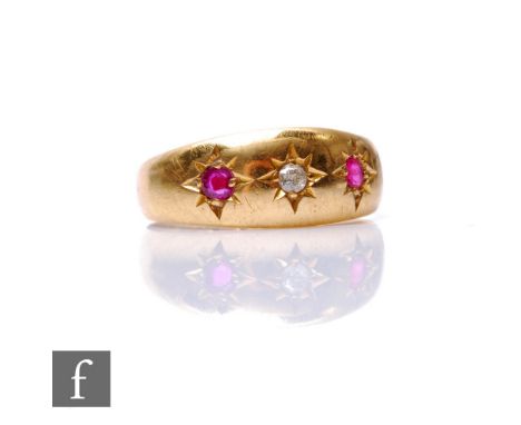 An 18ct hallmarked ruby and diamond three stone ring, gypsy set stones to a plain boat shaped head, weight 3.5g, ring size K,
