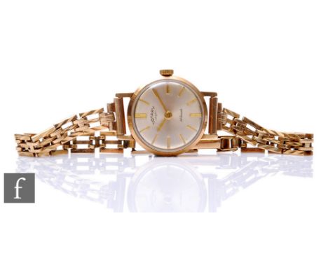 A 9ct hallmarked lady's Rotary manual wrist watch, batons to a silvered dial and fitted 9ct three bar gate bracelet, total we