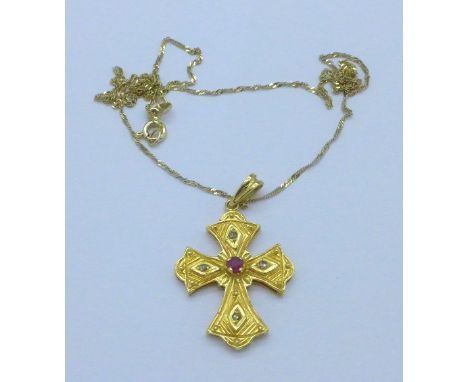 A yellow metal cross pendant with four old cut diamonds and one ruby on a chain stamped 585, total weight 5.5g