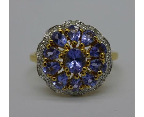 A silver gilt, tanzanite and diamond cluster ring, W