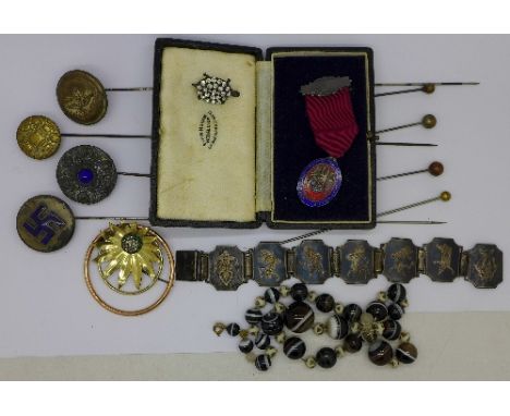 A collection of hat pins, agate beads, a paste tortoise brooch, a bracelet and a silver and enamel blood transfusion medal an