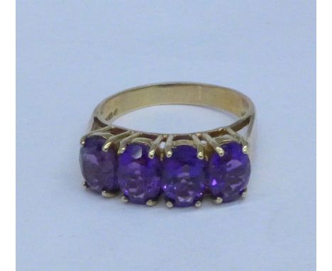 A 9ct gold, four purple stone ring, 3.9g, P