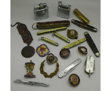 Early 20th Century enamel badges by Gaunt, pocket knives and two lighters