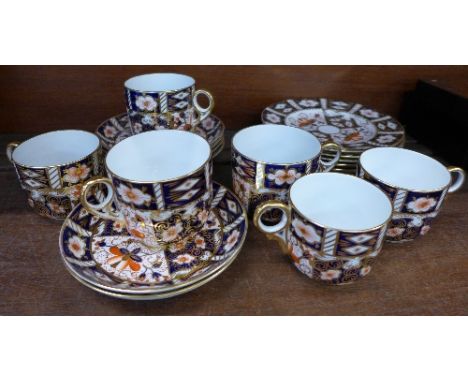 A collection of Royal Crown Derby 2451 pattern tea ware comprising six cups, (3+3), six saucers, (5+1), and six side plates