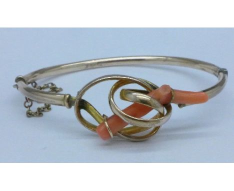 A yellow metal and coral twig bangle