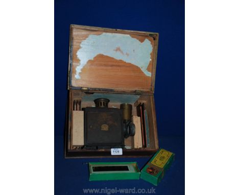 A vintage tinplate toy Magic Lantern with three boxes of coloured slides, in original box