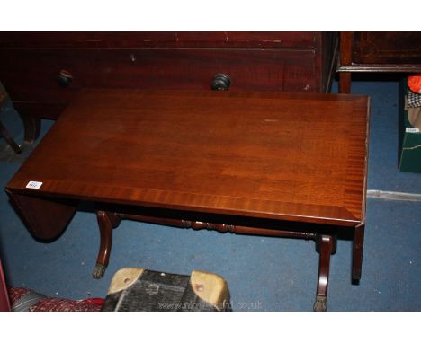 A reproduction Georgian style drop leaf sofa style Table on turned pedestal base with stretcher and splayed legs with lion pa