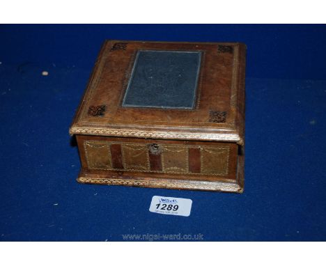 An elegant square Box probably 19th c. French, of wooden construction with tooled leather exterior and embossed lead panel to