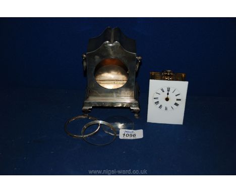 An elegant Silver cased Mantle Clock (for restoration) with French movement and enamel face, retailed by Stewart Dawson Ltd.,