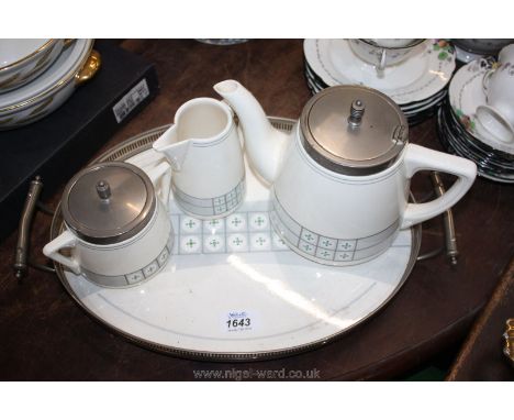 A teapot, milk jug (a/f) and sugar bowl on a matching ceramic tray with metal pierced gallery