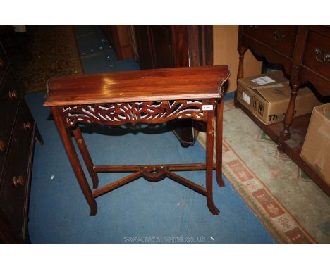 A reproduction Mahogany Console/Hall Table with shaped top over pierced, fret cut frieze on square legs with sabre style feet