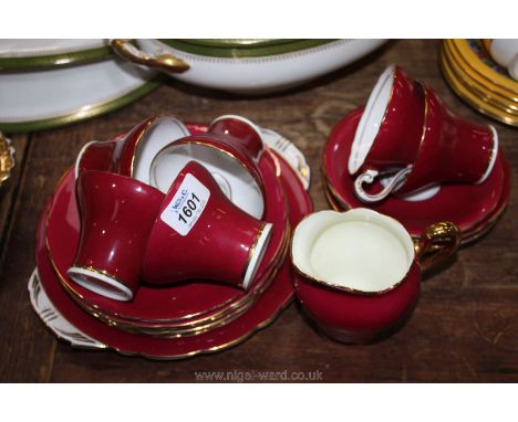 An Aynsley red gilded vintage part Teaset including six cups, six saucers, six tea plates, milk jug and cake plate