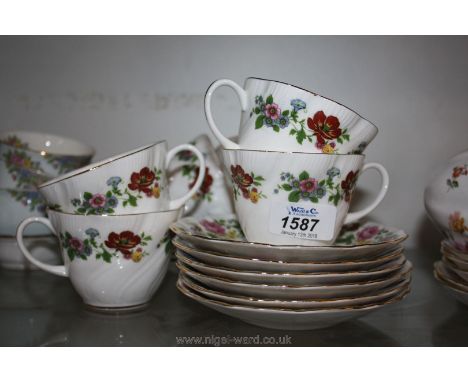 A fine bone china Royal Sutherland, Staffordshire part Teaset in multi-coloured dog rose pattern on white ground including si