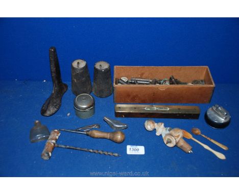 A box of miscellanea including corkscrew, novelty wooden wine stopper, W.A. Martin brass and wooden spirit level, two bone fe