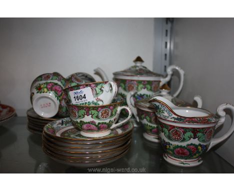 A pretty Chinese famille rose Teaset including six cups, six saucers, six tea plates, milk jug, sucrier with lid and teapot, 