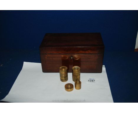 A Victorian Mahogany Tea Caddy, shaped borders to the front and lid, wooden escutcheon, containing two 50g brass weights and 