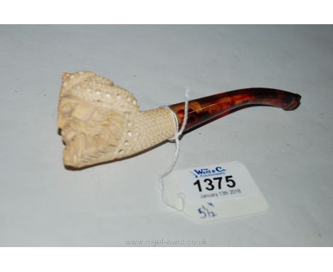 A carved ceramic Pipe in the form of an Eastern man's head, with mock tortoiseshell stem, 5 1/2" long