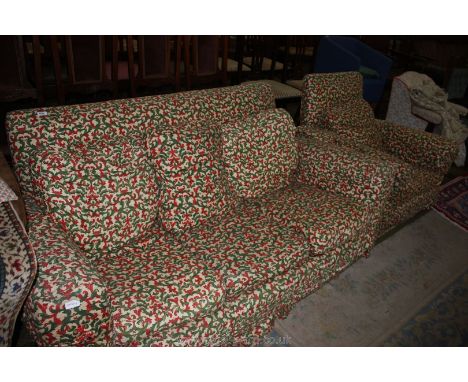 A Deco style two seater Sofa and matching Armchair with loose covers being cream ground stylized floral red and green pattern