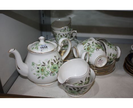 A Colclough Teaset decorated with pale green flowers on white ground including teapot, milk jug, sugar bowl, six cups and sau