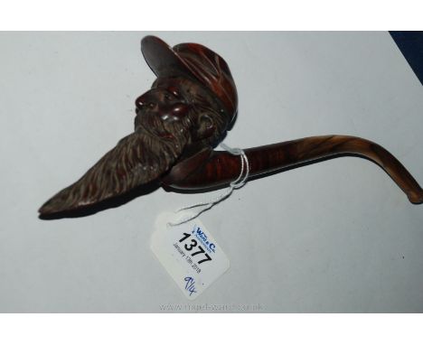 A superbly carved Briar Pipe in the form of a bearded man wearing a cap, possibly American Civil War period, the curved stem 