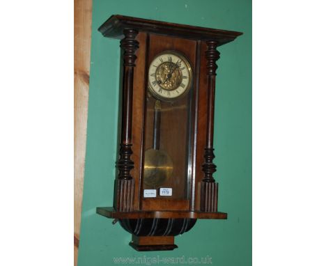 A 19th c. Walnut cased Vienna Wall Clock with embossed brass and enamel face, single pane glazed door, with brass pendulum, 1