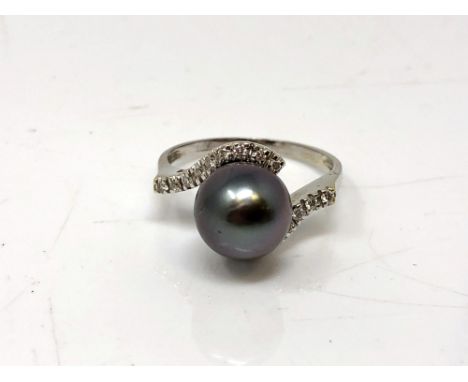 An 18ct white gold pearl and diamond ring, size P.  CONDITION REPORT: 5g